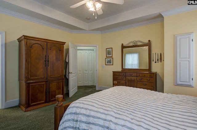 carpeted bedroom with crown molding, ceiling fan, and a closet