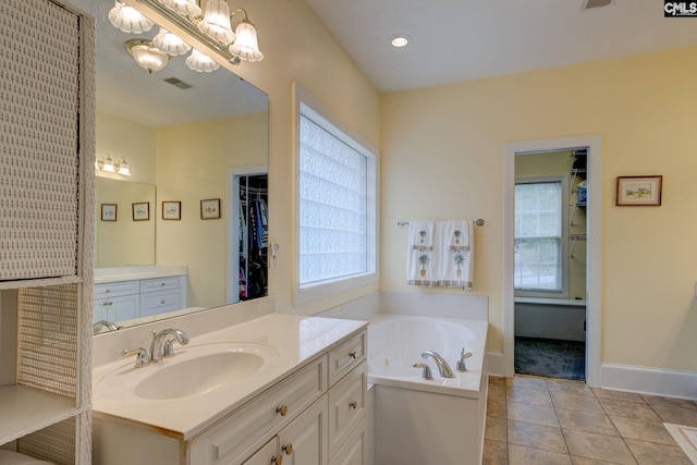 bathroom featuring a tub, tile patterned flooring, and vanity