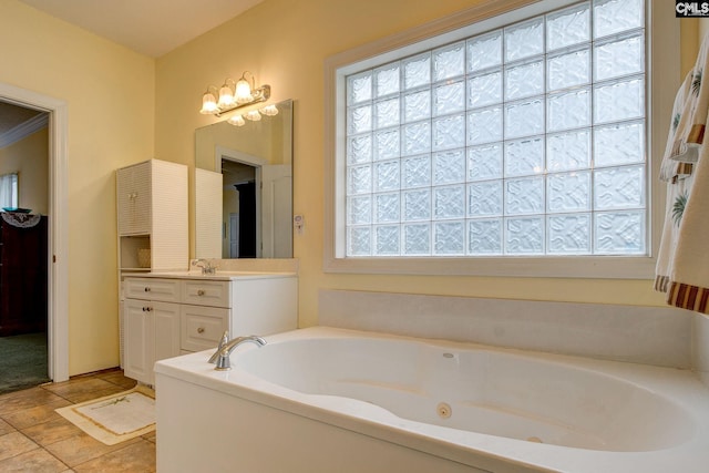 bathroom featuring a tub, plenty of natural light, and vanity