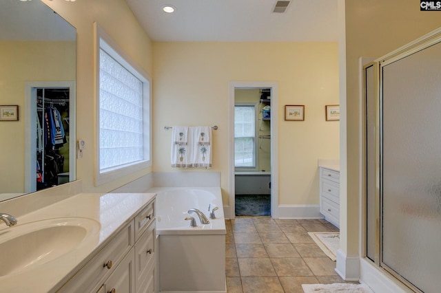 bathroom with plus walk in shower, tile patterned floors, and vanity