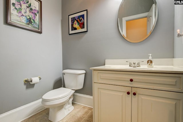 bathroom featuring tile patterned floors, toilet, and vanity