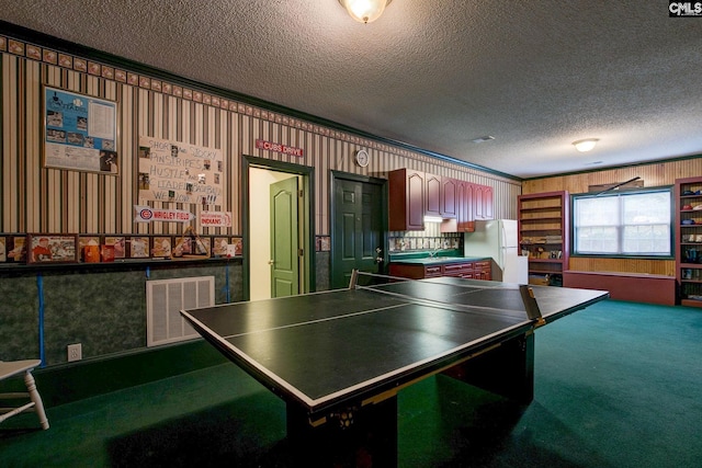 rec room with a textured ceiling and carpet floors