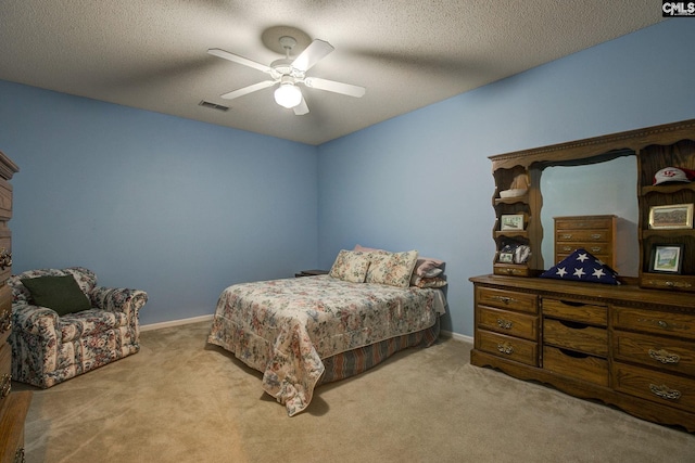 bedroom with light carpet, a textured ceiling, and ceiling fan