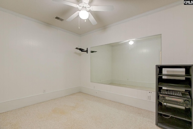 spare room featuring crown molding, ceiling fan, and carpet flooring