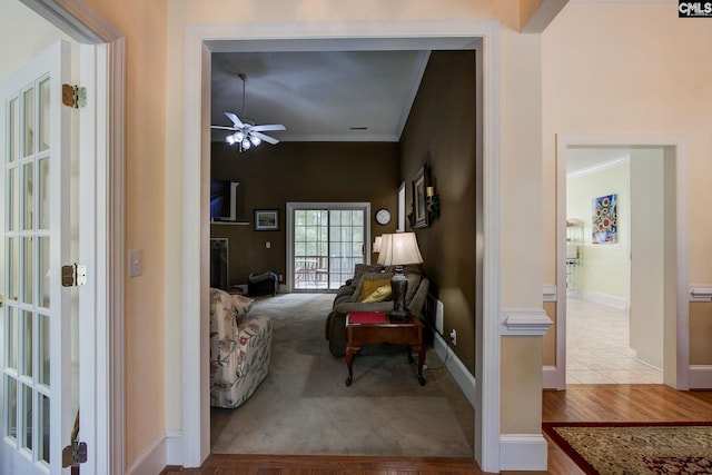 sitting room featuring ceiling fan, crown molding, and light hardwood / wood-style flooring