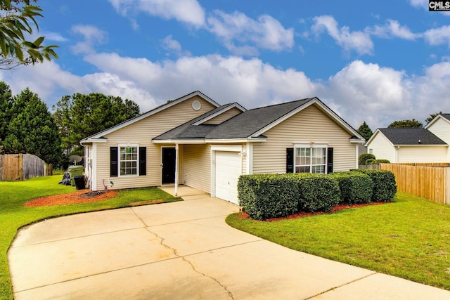 ranch-style house featuring a front yard, an attached garage, fence, and driveway