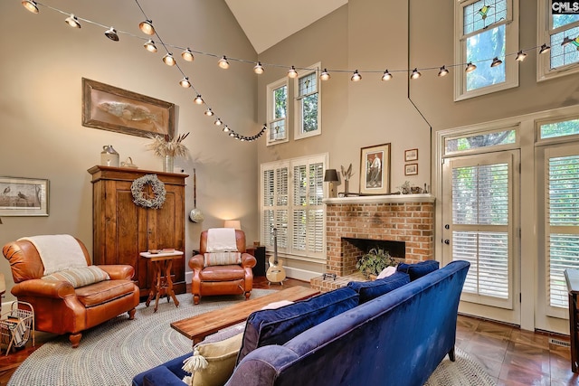 living room featuring high vaulted ceiling, a wealth of natural light, and a fireplace