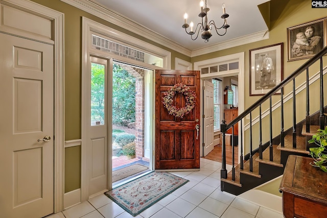 entrance foyer with crown molding, plenty of natural light, a notable chandelier, and light tile patterned floors