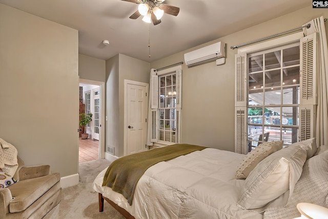 carpeted bedroom featuring a wall mounted AC and ceiling fan