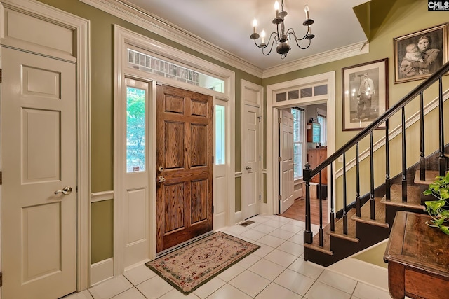 foyer featuring light tile patterned floors, a chandelier, and ornamental molding