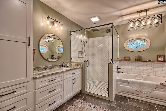 bathroom with vanity, independent shower and bath, and tasteful backsplash