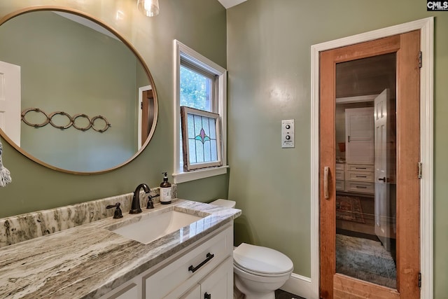 bathroom featuring vanity and toilet