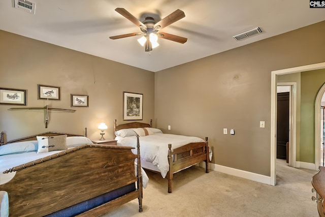 bedroom with ceiling fan and light carpet