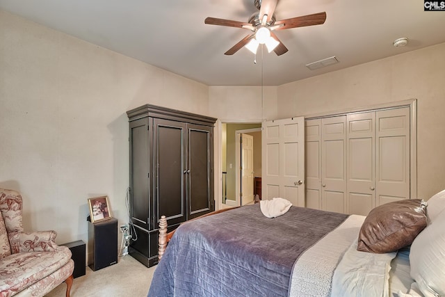 carpeted bedroom featuring a closet and ceiling fan