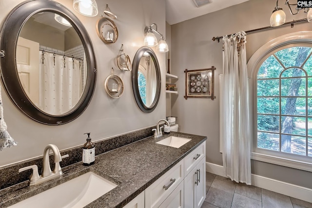 bathroom with tile patterned flooring and vanity