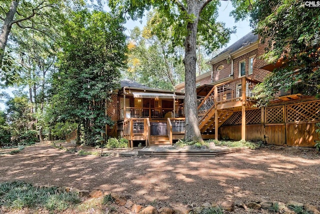 rear view of house with a wooden deck