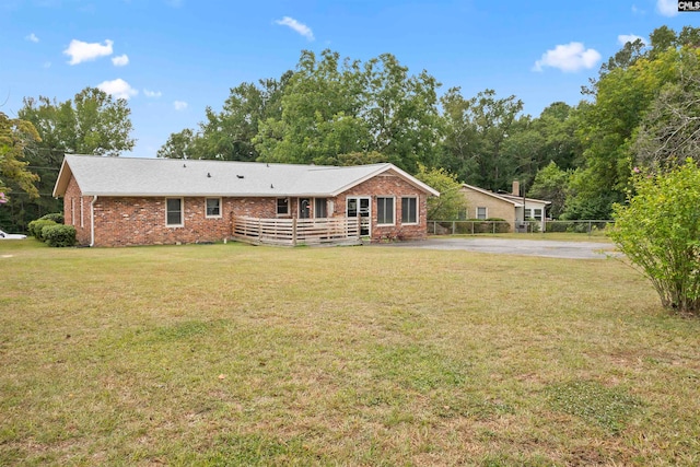 back of house with a lawn