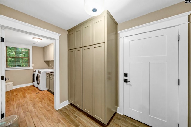 interior space featuring light hardwood / wood-style floors, cabinets, and washer and dryer