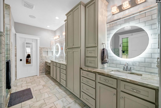 bathroom featuring vanity, tile walls, and backsplash