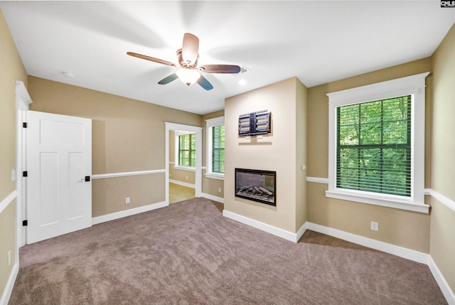 unfurnished living room with ceiling fan and light carpet