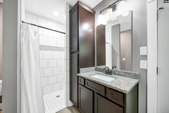 bathroom featuring vanity, a shower with curtain, and tile patterned floors