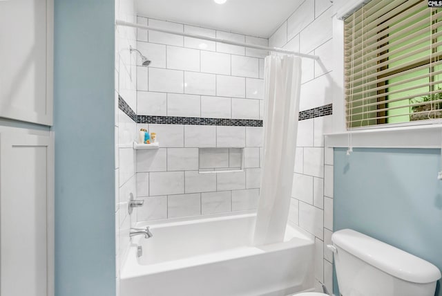 bathroom featuring shower / bath combo and toilet