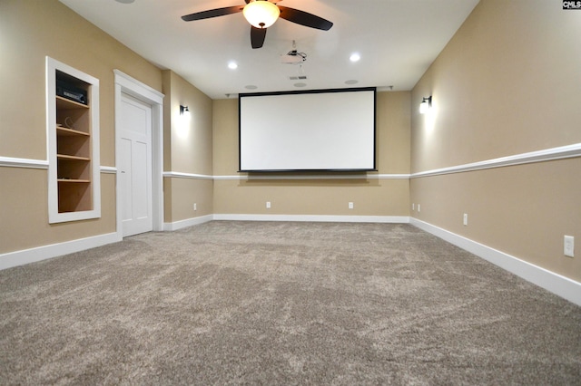 cinema room with ceiling fan and carpet floors