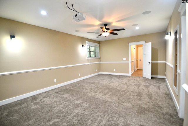 empty room with ceiling fan and carpet floors