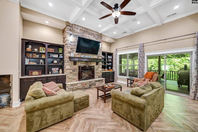 living room featuring ceiling fan, beam ceiling, light parquet floors, and a stone fireplace