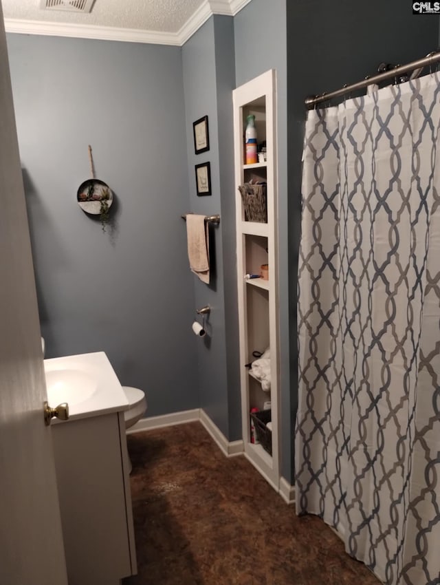 bathroom featuring a textured ceiling, vanity, toilet, and crown molding