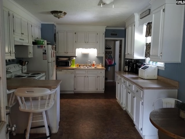 kitchen featuring a sink, white cabinetry, white appliances, and under cabinet range hood