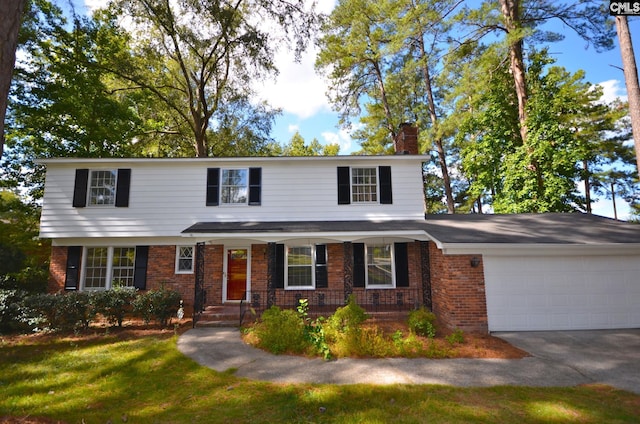 view of front of home featuring a front yard, a garage, and a porch