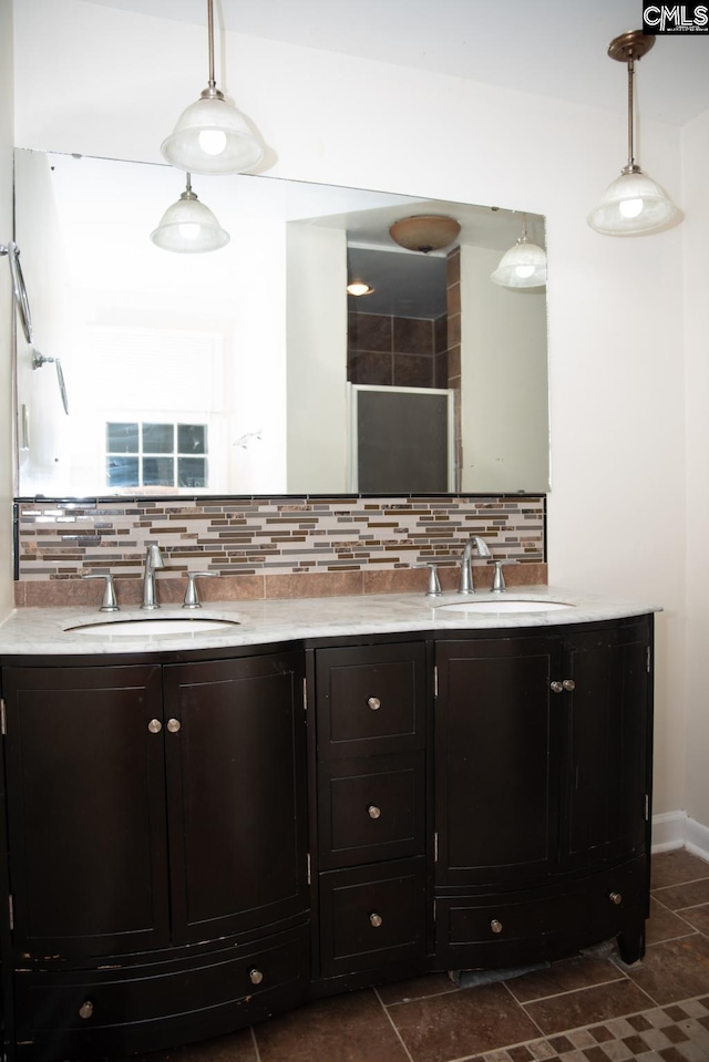 bathroom featuring vanity and tasteful backsplash