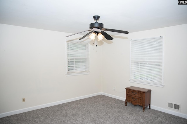 spare room with a healthy amount of sunlight, ceiling fan, and carpet flooring