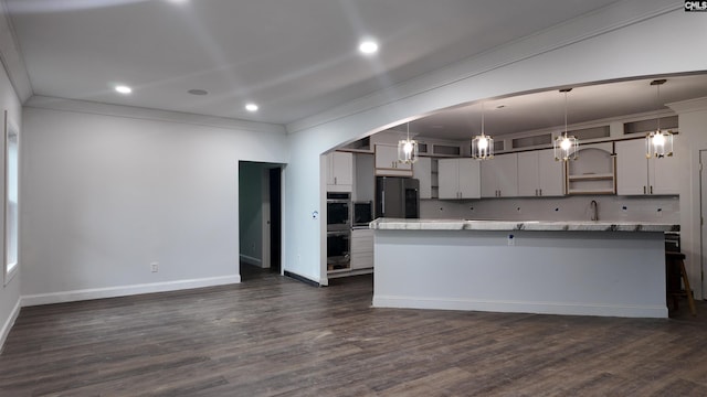 kitchen with ornamental molding, hanging light fixtures, black refrigerator with ice dispenser, and dark hardwood / wood-style flooring