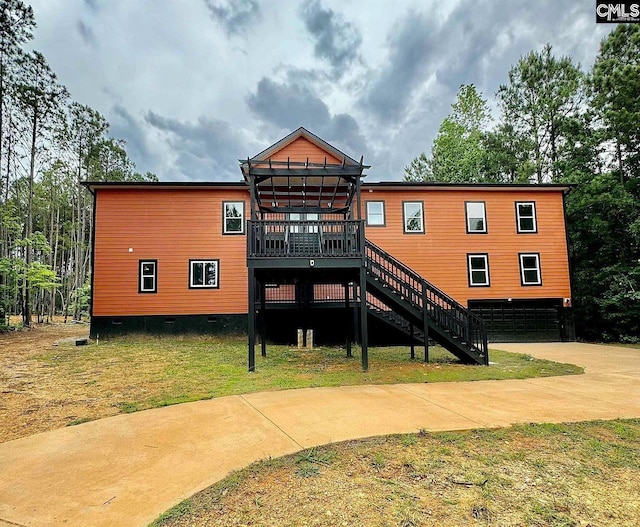 205 Miles Oak Ln, Blythewood, SC 29016 - rear view of property featuring a wooden deck, a garage, a lawn, stairway, and concrete driveway
