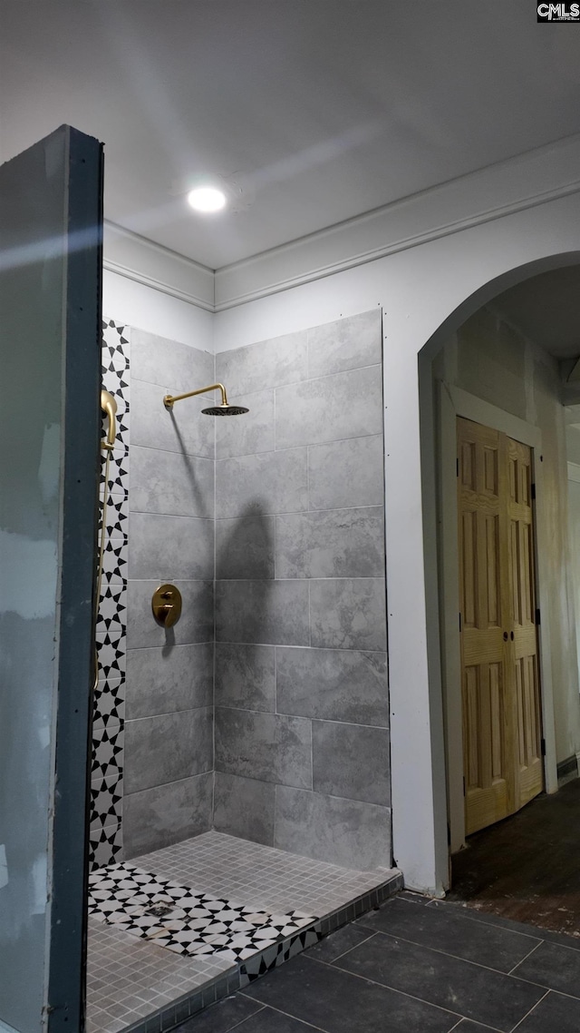 bathroom featuring wood-type flooring and tiled shower