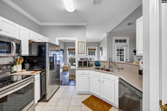 kitchen with light tile patterned floors, appliances with stainless steel finishes, white cabinetry, crown molding, and sink