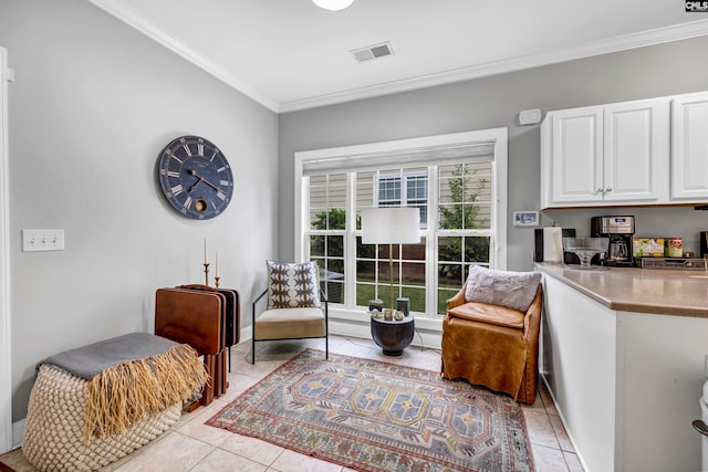 sitting room with ornamental molding and light tile patterned flooring