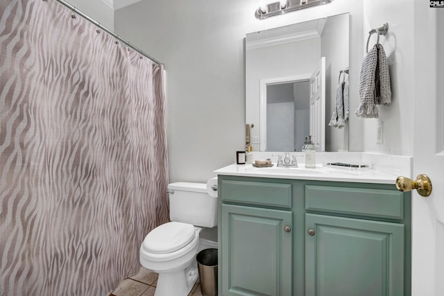 bathroom with vanity, toilet, crown molding, and tile patterned floors