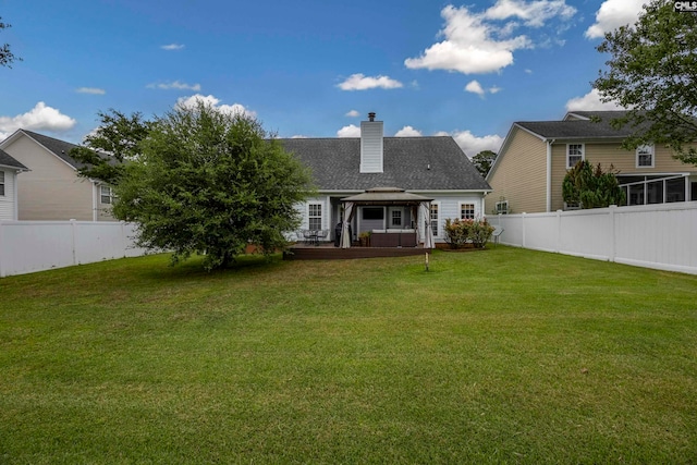 back of house featuring a lawn