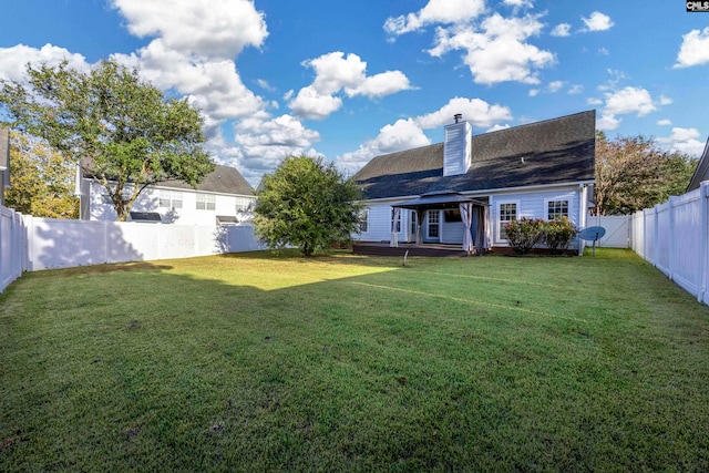 rear view of house with a yard