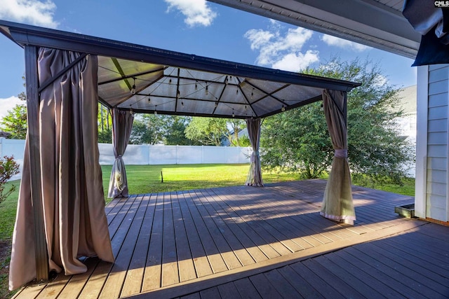 deck featuring a gazebo and a yard