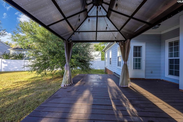 wooden terrace with a gazebo and a lawn