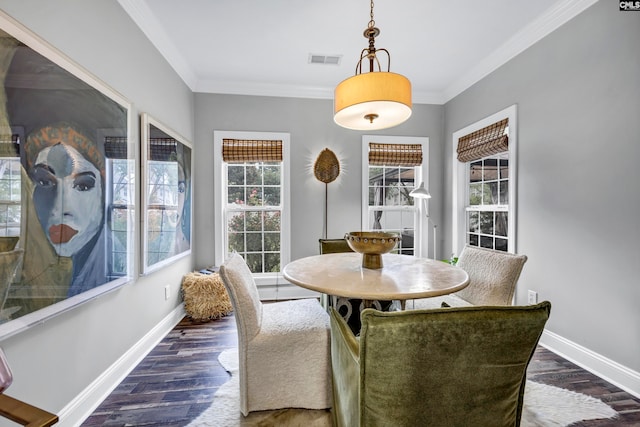 dining area with ornamental molding and dark hardwood / wood-style floors