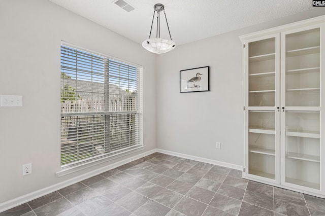 spare room featuring a textured ceiling