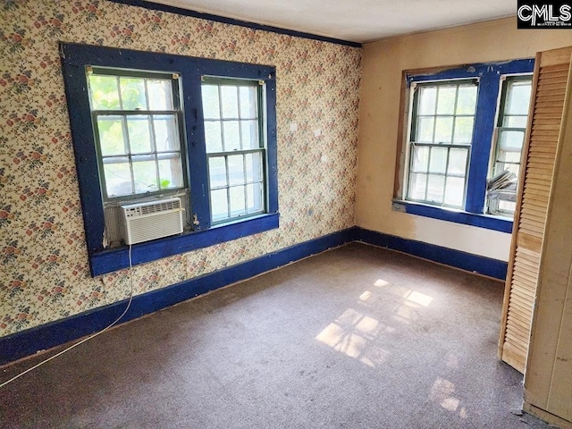 empty room with cooling unit, carpet, and ornamental molding