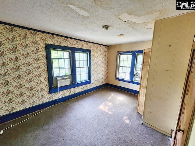 spare room with a textured ceiling and cooling unit