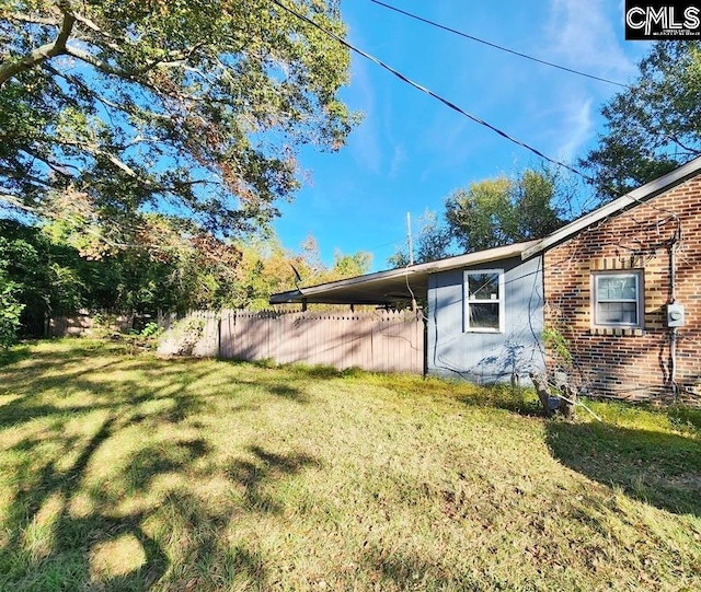 view of side of property with a lawn