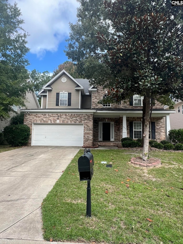 view of front of property with a front lawn and a garage